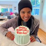 Renée Elise Goldsberry Instagram - I’ve been cranky on my birthday as long as I can remember. Too much pressure on this day to feel special, and that’s too much to ask of January 2nd—THE MOST SOBERING DAY OF THE YEAR. Feel sorry for my family on January 2nd. They try. They sing to me at some point, and I smile and say thank you, but my eyes can’t hide my disappointment that everyone everywhere is un-decking the halls and starting their diets on my day. This one didn’t start any better. My already sleep deprived family went to bed at 11pm last night because we had to catch a 6am flight home. I woke up at 1am to a drunken mob of Michigan fans who were screaming outside of our hotel room until 30 mins before our alarm. TSA chose THIS day to randomly test my hands, and for some strange reason I failed! My family looked on with pity as I was full and I mean FULL body groped at security like a terrorist, in front of hordes of strangers. ( I didn’t know they went under your shirt and waist band! Really guys?) But in the back middle of this plane I am on, the WiFi is working, and the happy birthday texts are coming through and reminding me how great this birthdate is. It’s so early in the year, a lot of people remember January 2nd! 1-2, Baby! And I always get a pre-birthday surprise party during New Year’s Day Dinner! That counts! So I’m posting my New Year’s Day pre-birthday cake, and the last moments of a spontaneous revival we had last night! (The bottle of wine opened for me was SOOOO good we had to call it communion!) I blew out that pre-birthday candle yesterday bursting with gratitude for my family and for my friends. I’m grateful that I’m never sad about getting older. I’m grateful for the MIRACLE of another year. Life is precious! Love is all around me! And there is still so much to celebrate! Even on the day after the parade! #january2 #embraceyourbirthday #thebloodthatgivesmestrength #itwillneverloseitspower