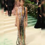 Rita Ora Instagram - My 10th MET! Thank you @voguemagazine. This years theme: Sleeping Beauties: Reawakening Fashion. This dress encapsulates in the most delicate and powerful manner a real tapestry of human crafts spanning a period of two millennia from Egypt to Rome. ⌛️⏳💫❤️ It is composed of one of a kind antique glass beads from all over the world, highlighting one of humankind’s most ancient crafted objects and paired together with antique handmade glass beads from Murano ranging between the 40’s all through to the 70’s. It has been constructed as if all the vertical beads have been weaved together to make an intricate pattern play between colour and texture. The verticality of the dress elongates the silhouette, and the slight tension around the waist exhale the curves of the body further. It is all hanging from a beautiful handmade metal structure that adorns the neckline almost as a jewel and defines it in a very graphic way. Thank you dream team 💫🥹⏳ @Marni @asliceofbambi Jewellery: @buccellatimilan Makeup: @makeupbyrhc @charlottetilbury @charlottetilburyskincare Hair: @brentlawler and @typebea Styling: @pippa.atkinson Photographer: @ppress_photography Videographer: @melissespinosa @metcostumeinstitute @voguemagazine @gettyentertainment