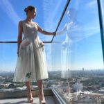 Rosamund Pike Instagram - Days of wine and roses. Long have I wished to wear a dress by @simonerocha_ This felt whimsical and witty and painterly for the @bafta tea party at the Maybourne Hotel which was on a terrace decorated with red roses! Thank you @leithclark for the joy, @kyleeheathhair for the beautiful bun @tamah_krinsky for the face magic. And @prosper_pr for it all.