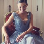 Rosamund Pike Instagram - 2 weeks since the @bafta film awards in London. I flew from Cape Town where I am working, and slipped back into London life for 2 days; or at least a fantasy version of London life where I dressed in Dior, and got ready at the Ritz, and borrowed playfully exquisite jewellery from Boucheron … a fantasy life, which is not mine, and which will always have its Cinderella moment when the coach turns back into a pumpkin. But that is part of the story. Magical, because when you’re back in a hoodie queuing for an 11 hour Monday night flight from Heathrow, you wonder if any of it was real. These photographs, shot by Simon Emmett, are from while the magic lasted! Look at the Boucheron bow inspiring the bow in my hair; and the way this dress moves!! A liquid silk that flows so beautifully, and a colour that seems to glow. A dress to lose in! And get got lost in. @theritzlondon @bafta @dior @boucheron @davidebarbieri_ @amanda.grossman @leithclark @simonemmettstudio