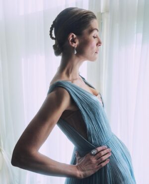 Rosamund Pike Instagram - 2 weeks since the @bafta film awards in London. I flew from Cape Town where I am working, and slipped back into London life for 2 days; or at least a fantasy version of London life where I dressed in Dior, and got ready at the Ritz, and borrowed playfully exquisite jewellery from Boucheron … a fantasy life, which is not mine, and which will always have its Cinderella moment when the coach turns back into a pumpkin. But that is part of the story. Magical, because when you’re back in a hoodie queuing for an 11 hour Monday night flight from Heathrow, you wonder if any of it was real. These photographs, shot by Simon Emmett, are from while the magic lasted! Look at the Boucheron bow inspiring the bow in my hair; and the way this dress moves!! A liquid silk that flows so beautifully, and a colour that seems to glow. A dress to lose in! And get got lost in. 
@theritzlondon 
@bafta 
@dior 
@boucheron 
@davidebarbieri_ 
@amanda.grossman 
@leithclark 
@simonemmettstudio