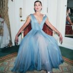 Rosamund Pike Instagram - 2 weeks since the @bafta film awards in London. I flew from Cape Town where I am working, and slipped back into London life for 2 days; or at least a fantasy version of London life where I dressed in Dior, and got ready at the Ritz, and borrowed playfully exquisite jewellery from Boucheron … a fantasy life, which is not mine, and which will always have its Cinderella moment when the coach turns back into a pumpkin. But that is part of the story. Magical, because when you’re back in a hoodie queuing for an 11 hour Monday night flight from Heathrow, you wonder if any of it was real. These photographs, shot by Simon Emmett, are from while the magic lasted! Look at the Boucheron bow inspiring the bow in my hair; and the way this dress moves!! A liquid silk that flows so beautifully, and a colour that seems to glow. A dress to lose in! And get got lost in. @theritzlondon @bafta @dior @boucheron @davidebarbieri_ @amanda.grossman @leithclark @simonemmettstudio