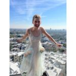 Rosamund Pike Instagram – Days of wine and roses. Long have I wished to wear a dress by @simonerocha_  This felt whimsical and witty and painterly for the @bafta tea party at the Maybourne Hotel which was on a terrace decorated with red roses! 

Thank you @leithclark for the joy, @kyleeheathhair for the beautiful bun @tamah_krinsky for the face magic. And @prosper_pr for it all.