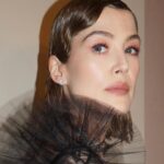 Rosamund Pike Instagram - Hello again. Getting ready for a Wedding in London and thinking the last time I got dressed up was for @dior ‘s spectacular ball in Venice in April .. I never shared the pictures of the look created by maestro @davidebarbieri_ and @valeriaferreiramakeup that befitted a night walk through torch lit streets guided by men shadowed by umbrellas and capes to the opera house… to @mariagraziachiuri ‘s vision of how theatre, beauty and fashion can coincide in a mysterious, romantic dream.