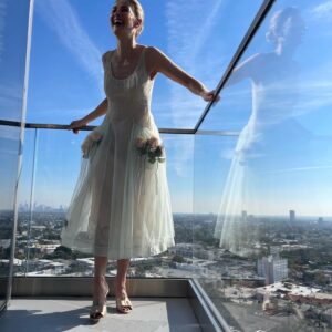 Rosamund Pike Instagram - Days of wine and roses. Long have I wished to wear a dress by @simonerocha_  This felt whimsical and witty and painterly for the @bafta tea party at the Maybourne Hotel which was on a terrace decorated with red roses! 

Thank you @leithclark for the joy, @kyleeheathhair for the beautiful bun @tamah_krinsky for the face magic. And @prosper_pr for it all.