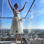 Rosamund Pike Instagram - Days of wine and roses. Long have I wished to wear a dress by @simonerocha_ This felt whimsical and witty and painterly for the @bafta tea party at the Maybourne Hotel which was on a terrace decorated with red roses! Thank you @leithclark for the joy, @kyleeheathhair for the beautiful bun @tamah_krinsky for the face magic. And @prosper_pr for it all.