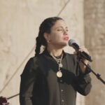 Salma Abu Deif Instagram – Self talk to the root letter,
I’m Salma, a North African, Middle Eastern, Egyptian millennial, born and raised in Cairo in 1993. I was brought up to know God through Islam in a beautiful spiritual way. I grew up to know all Fayrouz’s songs and Soaad Hosni’s and Omar el Sherif’s movies. I was raised to gather every Ramadan with my beloved ones from family and friends. I knew Ramadan’s lights and the city that never sleeps. I grew up in an Egyptian education system knowing my country’s culture and history, learning about every other colonized country in our region to the point that I got lost between all of them. I grew up knowing my beloved country through our history and people till it got embodied in us. I grew up on the note that when you are living in bad circumstances, you always give to the other and thank God anyway . I grew up on the generosity of the people in my culture, learnt as if it’s an insult not to be a good host. I grew up with a Palestinian best friend who knew nothing but pureness of hearts until she had to leave to anther country. I grew up knowing makdoos and finally got to know who Handala is, from her. I grew up knowing family always comes first. I grew up knowing betrayal is a sin, And lying is another sin. I grew up knowing pharaohs and queens until i dreamt about that they might be one of my ancestors. I grew up on Umm khalthoum and Abdelhaleem Hafez knowing that when I grew up their lyrics would hit my heart hard. And I learnt the sense of humor of Egyptians is an escape of what true reality is. I grew up on waking up and going to school at 5:00 am in the morning and next thing I see and hear on tv is mama saying “el Iraq is at war!!!!” I grew up on watching Mohamed Elduraa’s assassination in his father arms on tv on 30 September 2000 and watching kids fight with stones. I grew up knowing of a city called Tullkarm and that’s where Farah is from. I learnt that best olives is in Tulkarm but I never visited Tulkarm. I learnt new acting skills through a Jewish Colleague. And that a teacher and guru in life can be a Christian teacher or a priest. I grew up rooted in love, beauty, laughter, and faith.
Who is your root self habeeby