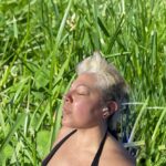 Sara Ramirez Instagram - Pic of me in the grass, eyes closed, tuning into my calling and purpose, to my joy and pleasure, to the love in my life, to the truth and wisdom, to the pain and grief, to what feeds my soul, to the people who are for humanity and against genocide and apartheid, to the people who were and are advocating for a higher standard of Liberation, to our healed ancestors trancestors and spirits, to the winds of change. Let me grow or let me go. It’s time to take a hiatus from this digital space. I’m grateful for community that shows up for the collective in person and/or in meaningful ways outside of this digital space. Grateful for grace and compassion, for softness as strength. Grateful for chosen family, friends, loved ones and comrades who understand the value of reciprocity and true community care as love. Grateful for community that checks up on me outside of social media and wants me in their lives not for extraction or transactional relationship, but for the practice of hope and transforming our rage into action together. Some threw me away but really didn’t get that I’m a seed and I continue to grow. At times I threw myself away but really didn’t get that I am part of a continuum and ocean of power and beauty, and will continue to contribute to the collective no matter where I land or who is there to receive me. May you all continue to look to your own gardens for the truth about yourselves. May you all gather the strength and courage to confront and manage your own conditioning and internalized oppressions. May you all be surrounded by the support and love to heal and grow and learn something new about yourselves. May you land on soft grass and be open to the winds of change in your hearts and minds. None of us are free until all of us are free. ☀️🌱❤️‍🔥 P.s. I’ve found that there has been no better space for confronting my own humanity, raggedy ways, imperfection, conditioning, need to unlearn/learn than activism spaces. Thank you activism community for inspiring/empowering me to confront, reflect, heal/manage my pain/conditioning/trauma into something that nourishes and fortifies the gardens of Liberation we are growing together. Progress>perfection🌿