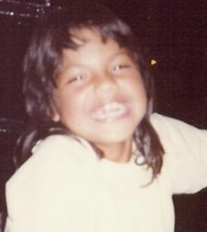 Sara Ramirez Instagram - Pic of Sara, at around 8 years old, wearing a light yellow shirt, a huge smile, and an early 80s mullet. 

Second pic is of 2 books; Sara’s extra flowery “This is the Story of” baby book open to the Baby’s Arrival page with birthday info, and the very serious looking Fathers Labor Coaching Log and Review Book because 1975. 

There is so much to say but I’m gonna keep it simple. You’re welcome.

Happy birthday to me! May this kid continue to feel and know that they are loved beyond their gender, they are valued beyond their productivity, and they will always be held and protected by this softening blossoming adult who may or may not be bringing their killer mullet back.