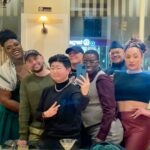Sara Ramirez Instagram - Thank you to community for keeping one another safe, and affirming the world we know is possible. It’s nights like this one that keep me going. What a time to be alive. . . 2 pics of the same group selfie taken by Sagan inside a restaurant, with NYC through the windows looking out behind us: 1st one is from further away with Qween, Sawyer, Sagan, me, Sloane, Ianne and Crayton in various forms of smile and love energy, the 2nd pic is a close up of the same group similar vibes.