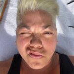 Sara Ramirez Instagram - As much space as I make for anger/rage/sadness, it is imperative that I make as much- if not more- space for joy and pleasure. I’m a human being who deserves love, joy, pleasure, silliness, fun, and for my whole self to be accepted and respected. Here is some of my joy in recent days! . . Pic 1: selfie of me squinting in the sun cosplaying Billy Idol with a curled lip, recently changed hair to platinum, laying on a towel with my sunglasses and Parable of the Sower (yes! It took me forever to read it! Yes! I struggle with staying focused when reading! :)) as I soak in the first rays of Spring. Pic 2: Mio in the midst of capturing one of his fave toys in his mouth. Pic 3: Me and Sawyer selfie, out and about having fun! He’s got cute glasses on and an olive beanie. I’m, of course, wearing black. Pic 4,5,6: beautiful blooming Spring at Brooklyn Botanical Gardens, Sawyer taking a pic, and a video of gorgeous reds blooming. Pic 7: my red nails for Red Ink at Joes Pub. I wonder why my middle finger nails are watermelon art? 🤔🍉 Pic 8,9: selfies of me and @trudy0nduty at the park loving on each other with hugs and smooches. Big bright yellow blooming behind us. Video: me being silly, making my own music, being in on all the jokes. We must have JOY to counteract and resist the systems that would rather we didn’t exist. 👋🏽🥰❤️‍🔥☀️🪻🌱