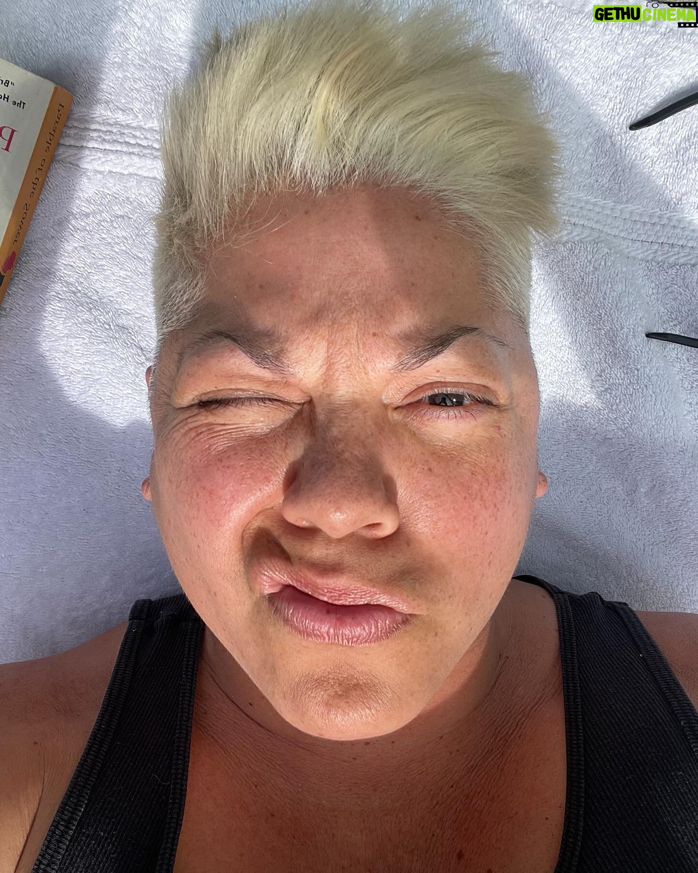 Sara Ramirez Instagram - As much space as I make for anger/rage/sadness, it is imperative that I make as much- if not more- space for joy and pleasure. I’m a human being who deserves love, joy, pleasure, silliness, fun, and for my whole self to be accepted and respected. Here is some of my joy in recent days! . . Pic 1: selfie of me squinting in the sun cosplaying Billy Idol with a curled lip, recently changed hair to platinum, laying on a towel with my sunglasses and Parable of the Sower (yes! It took me forever to read it! Yes! I struggle with staying focused when reading! :)) as I soak in the first rays of Spring. Pic 2: Mio in the midst of capturing one of his fave toys in his mouth. Pic 3: Me and Sawyer selfie, out and about having fun! He’s got cute glasses on and an olive beanie. I’m, of course, wearing black. Pic 4,5,6: beautiful blooming Spring at Brooklyn Botanical Gardens, Sawyer taking a pic, and a video of gorgeous reds blooming. Pic 7: my red nails for Red Ink at Joes Pub. I wonder why my middle finger nails are watermelon art? 🤔🍉 Pic 8,9: selfies of me and @trudy0nduty at the park loving on each other with hugs and smooches. Big bright yellow blooming behind us. Video: me being silly, making my own music, being in on all the jokes. We must have JOY to counteract and resist the systems that would rather we didn’t exist. 👋🏽🥰❤️🔥☀️🪻🌱