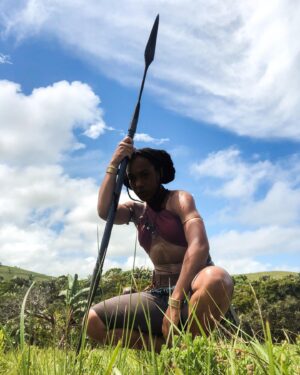 Shaina West Instagram - “Turn your back and see how true my aim is.”

The name is “ESI”, Agojie Army Lieutenant & Spear of Dahomey. 

#TheWomanKing @womankingmovie @womankingfilm