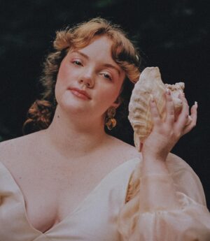 Shannon Purser Instagram - 🌷✨Backwoods Venus✨🌷

when I first saw these photos after our shoot in the summer, I didn’t know how to feel. they were beautiful. everything Valheria does is beautiful. she’s a true visionary and I consider myself so lucky every time we get to shoot together. the whole team behind these pictures is amazing and even though it was a humid, sweaty shoot in a creek that probably had snakes, it was a great day. so what was the hesitation?

I felt exposed. I felt overwhelmingly aware of my body and how short it falls of the beauty standards our society has indoctrinated us with. indoctrinated me with. ever since I was maybe 10, I’d internalized the idea that fat is one of the worst things you can be. I learned that if you are fat, your options are to punish your psyche and your body until you are not or try to compensate however you can. I got good at makeup. I am strategic about how much skin I show and where. I cast myself as the “mom friend” even when it felt wrong because, in my mind, being desirable wasn’t really an option. 

I’ve realized over the years that I’m not just strategic about revealing my body. I’m strategic about revealing my soul- who gets to know me and how well. sometimes that’s wisdom. other times, it’s just a debilitating fear of vulnerability-a reflexive shrinking away from a potential hurt. 

what I do know is that the hiding hurts more than the exposure. dreading the moments someone wants to see me in my entirety, body and soul, hurts. so, here I am, exposing myself. I am not confident. I am just refusing to let my fear keep me from living. I am just me. 

photos: the legend herself, @valheria123 (she also did my nails bc what can’t she do?)
makeup: @chandlerwest 
custom clothing and styling: @studio.tessafay 
hair styling and extensions: @_treyanthony @jessicawrighthair @your.mane.thing @melrosemcqueen 
assistants: the iconic @demetriusw @savanaogburn