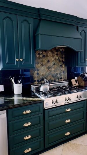 Sharna Burgess Instagram - Merry Christmas to me 🤩🤩 Kitchen rehab present from Bri. Thank you baby for knowing me so well this was THE best present ever. 

I am in love with this rich deep green color AND the hardware AND I even love the counter top now :) Its unreal what the right paint and little details can do. The placement of the handles is amazing too. We were about to do black because I love a black and white kitchen but it didn’t feel right in this space with the counter top and the moulding on our cupboard doors. This green feels like we’re embracing all the quirks that instead of hiding them. We’re on the search for the perfect island too. 

I know this is the lipstick version but wow am I obsessed. Thank you @brianaustingreen I love you so much and now I love our kitchen too! 😘♥️

#christmas #present #kitchendesign #homedecor #greenkitchen