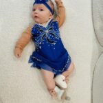 Tara Lipinski Instagram - Georgie’s 1st Halloween! ⛸️❄️ @bradgriffies made a costume that will be hard to match. Thank you!!!! Does anyone recognize it?! @toddkap commentated Gigi’s performance and I of course gave her an old school perfect 6.0 score of course! Brad - again thank you! It’s just too much. You are a talent and skaters are lucky to wear your beautiful designs. #babysfirsthalloween #halloween #newbornhalloween #figureskating #skating #olympics