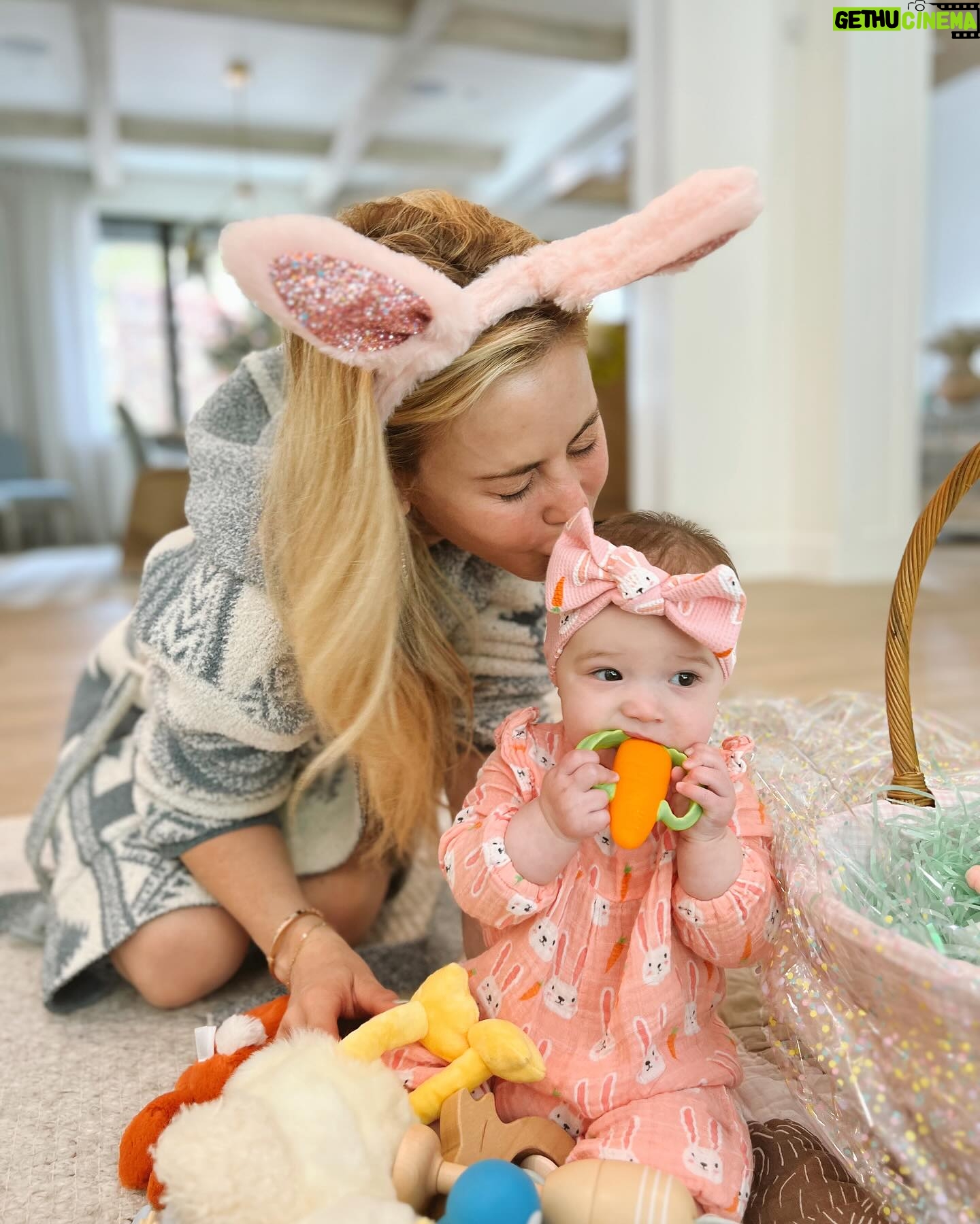 Tara Lipinski Instagram - Georgie’s first Easter and too many pics to count. Some of the ones that didn’t make stories. 🐰🥕 Our little family. 🫶 Hoping Sully thought the Easter basket was for him. Little man is so good with her, he just wants *needs* to part of everything. #easter #babysfirsteaster #babygirl #baby #6monthsold #parenting #babyanddog