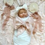 Tara Lipinski Instagram – *Missed the month mark by a long shot but got it in.
Just over here winging it the best way I can with this adorable little cuddle bug.🐞
What is not pictured is her houdini-ing her way out of the swaddle and Sully thinking the photo shoot was about him. But through the chaos I somehow got this one snapshot of our Georgie girl.
#daughter #motherhood
