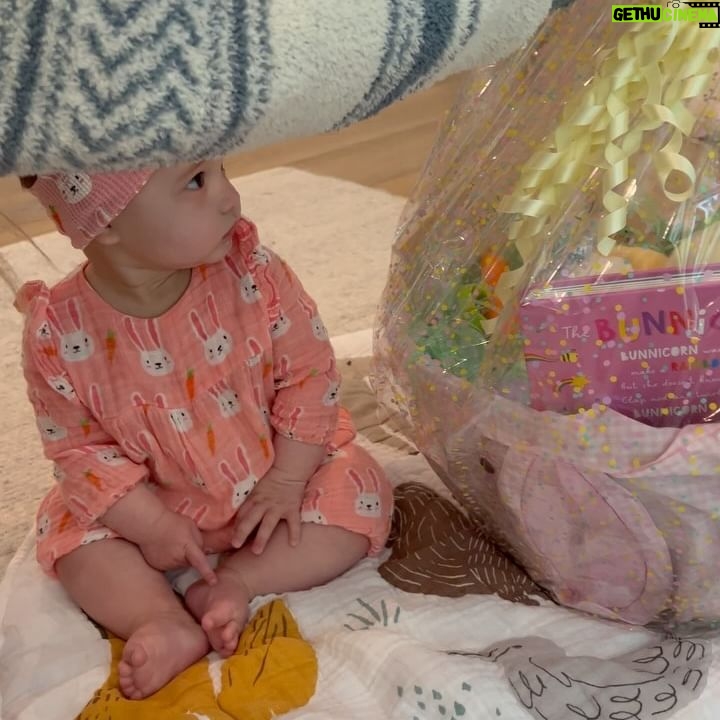 Tara Lipinski Instagram - Georgie’s first Easter and too many pics to count. Some of the ones that didn’t make stories. 🐰🥕 Our little family. 🫶 Hoping Sully thought the Easter basket was for him. Little man is so good with her, he just wants *needs* to part of everything. #easter #babysfirsteaster #babygirl #baby #6monthsold #parenting #babyanddog