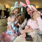 Tara Lipinski Instagram - Georgie’s first Easter and too many pics to count. Some of the ones that didn’t make stories. 🐰🥕 Our little family. 🫶 Hoping Sully thought the Easter basket was for him. Little man is so good with her, he just wants *needs* to part of everything. #easter #babysfirsteaster #babygirl #baby #6monthsold #parenting #babyanddog