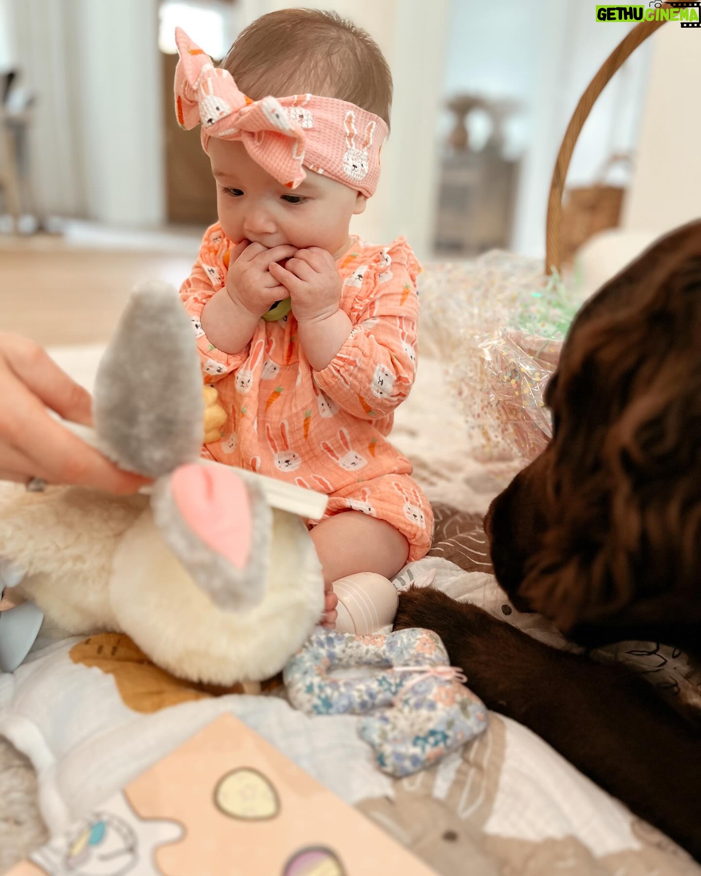 Tara Lipinski Instagram - Georgie’s first Easter and too many pics to count. Some of the ones that didn’t make stories. 🐰🥕 Our little family. 🫶 Hoping Sully thought the Easter basket was for him. Little man is so good with her, he just wants *needs* to part of everything. #easter #babysfirsteaster #babygirl #baby #6monthsold #parenting #babyanddog