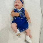Tara Lipinski Instagram - Georgie’s 1st Halloween! ⛸️❄️ @bradgriffies made a costume that will be hard to match. Thank you!!!! Does anyone recognize it?! @toddkap commentated Gigi’s performance and I of course gave her an old school perfect 6.0 score of course! Brad - again thank you! It’s just too much. You are a talent and skaters are lucky to wear your beautiful designs. #babysfirsthalloween #halloween #newbornhalloween #figureskating #skating #olympics