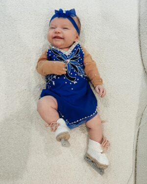 Tara Lipinski Instagram - Georgie’s 1st Halloween! ⛸️❄️

@bradgriffies made a costume that will be hard to match. Thank you!!!! Does anyone recognize it?! 

 @toddkap commentated Gigi’s performance and I of course gave her an old school perfect 6.0 score of course! 

Brad - again thank you! It’s just too much. You are a talent and skaters are lucky to wear your beautiful designs. 

#babysfirsthalloween #halloween #newbornhalloween #figureskating #skating #olympics