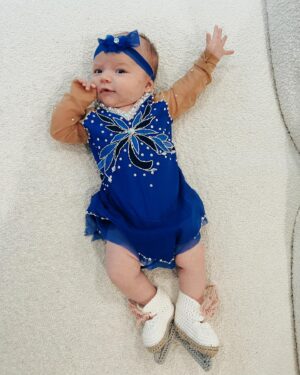 Tara Lipinski Instagram - Georgie’s 1st Halloween! ⛸️❄️

@bradgriffies made a costume that will be hard to match. Thank you!!!! Does anyone recognize it?! 

 @toddkap commentated Gigi’s performance and I of course gave her an old school perfect 6.0 score of course! 

Brad - again thank you! It’s just too much. You are a talent and skaters are lucky to wear your beautiful designs. 

#babysfirsthalloween #halloween #newbornhalloween #figureskating #skating #olympics