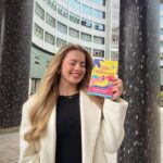 Tasha Ghouri Instagram - I’m so excited to finally show you all the cover of my first book, Hits Different! Thank you to @nicandlou and @beth_free_designs for creating such a stunning, summery, inclusive cover 🤍 Only 4 months left until Hits Different is out in the world. Representation was key for this book. I can’t wait for all of you to meet Cassie and join her on a summer of love, dance and adventure. It’s a journey about self love with her cochlear implant and finding her way to embracing her deafness! Also her non binary bestie who helps her along the way. Thank you @littlehux for bringing this book to life, you are an incredible talented writer! It’s been amazing to collab with you on this 🥹 Hits Different is out on June 6th with @hotkeybooks, and you can pre-order your copy now 💕🫶🏼🤍 AD