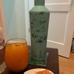Vanessa Marcil Instagram - This morning MC left this by our bed for me before he left for work. It’s a probiotic, crushed ice with carrot juice/tangerine that he juiced himself this morning 😳 and ginger that he went out and bought for me. The incredibly beautiful @corkcicle water container is my bday gift from Kassius. Kass wants me to drink water. I love everything about this side table right now. ☺️ #tobeknown #IAMarichman