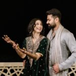 Vrushika Mehta Instagram - Mehendi night was filled with colours and giggles. We had a fun mission too – getting Saurabh to find his name in the mehendi design! 😄💍 Our families danced, laughed, and celebrated together, making it a beautiful night filled with love and joy. 💃❤️ Captured by: @smaryafilms Wearing: @gulabo_jaipur Jewellery: @neo_jewellers #rabhdivrushyy #mehndi