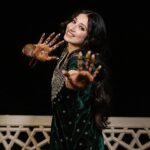 Vrushika Mehta Instagram - Mehendi night was filled with colours and giggles. We had a fun mission too – getting Saurabh to find his name in the mehendi design! 😄💍 Our families danced, laughed, and celebrated together, making it a beautiful night filled with love and joy. 💃❤️ Captured by: @smaryafilms Wearing: @gulabo_jaipur Jewellery: @neo_jewellers #rabhdivrushyy #mehndi