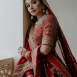 Vrushika Mehta Instagram - Picking the red lehenga wasn't just a choice; it was like making a dream come true. Everything worked out exactly how I wanted! Thank you @asopalav ❤️ And how can I forget the traditional yet elegant veil made by my mom and @_usha_maurya aunty ❤️ Captured by: @smaryafilms Jewellery: @paldzigns.jewel #rabhdivrushyy #wedding