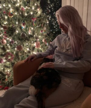 ALB in Wonderland Instagram - our Maymay passed away yesterday. She got very sick very quickly and we nursed her night and day hoping we could get her through this, but she was ready to go. We held her in our arms as she left. everyone who met her fell in love with her and the grief hangs so heavy.

I’ll never forget the first time I met her. I had flown to New Jersey to stay with Niko a few months after we started dating. We dropped by the house to leave luggage before going out to grab food, and I was sitting at the top of the stairs waiting for Niko to finish up getting ready so we could head out. A small but very round calico cat poked her head out from a bedroom and came out tentatively. I offered my hand and she sniffed it, before eagerly crawling into my lap and purring. I thought to myself, I’m so lucky! How often does a cat cuddle you right after meeting you!
Niko came out and stopped short when she saw us, to the point where I thought something was wrong.
It turns out Maymay was shy, so shy that even at 6 years old when I met her she had never climbed into the lap of another person besides Niko. 
About a year later she and Dawn would take their very long car trip from NJ all the way to Toronto to become little Canadian cats. And we made our family here. She lived to be over 13 years old.
I had never had a pet growing up. Every year I wrote in my letter to Santa that I wanted to have a little pet of my own, I made slide shows and pamphlets trying to convince my parents that I needed a furry friend. I made it into adulthood without one, and although I really loved animals I was completely unprepared to know how much I could love my May. 
She was more than just a cat to us. She was fully integrated into every part of our lives. With two mamas who worked from home, she was always with one of us, in our laps while we were doing a task or trotting behind us inspecting what we were looking at, loudly chiming in with her thoughts.
The winter solstice will always be your day Maymay. And I’ll always love you.