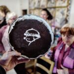 Agnès Varda Instagram - The chocolate cake of my 90’s , Le gâteau de mes 90 ans fait par Nadja décoré par Christophe d’après une idée de Julia après complot général des Amis. Photo @JR
