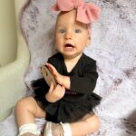 Alicia Banit Instagram – Cheeky munchkin is 11 months!

(And a day 😬)Oh my! As if she’s a month away from being ONE?! Every day keeps getting more and more fun, she brings so much joy to every single day! Especially when she’s having a laughing fit and snorts like a piggy! Girlfriend is on the move and crawling/trying to walk, she’s got her first molar with the other nearly through the gum and do I even need to say it? Has handled it like the champ she is! Her new favourite game is pretending to hand something to us to then steal it back, she thinks she’s hilarious! But also, she is. She’s poking her tongue out knowing she’s being cheeky, she loves talking and miss independent is so happy to play alone with her toys. Oh and can stand up in her cot! On the other hand she’s very clingy to mummy right now and loves cuddles. I think she’s actually a crocodile, she has that death roll at nappy change time down pat! She loooves dancing, she could hear music in the other room and will start to jig along to everyone’s delight and she definitely has the Wog gene, she uses her hands very expressively to emphasise the importance of what she’s saying 🤌🏼👈🏼. I can’t believe she’s one next month! The love I have for this little munchkin is indescribable, we are so lucky she’s ours 🤍