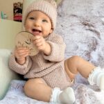 Alicia Banit Instagram - 9 months of our little miss 😍 Girlfriend is a professional clapper and loves to put on a show of waving and clapping most minutes in the day. She’s mastered Dadadada to the delight of Zac and the squeals that come out of her mouth make me think she was a dolphin in a past life. She will blow bubbles with her saliva which is hilarious, I remember sitting there for ages as a kid doing that and whenever she eats, miss independent must feed herself with her spoon. She loves sharing, a game of share the dummy before falling asleep is inevitable and the big sloppy kisses I’ve been getting melt my heart. Which is good cause she has also started scratching and slapping my face when she’s having a cry so honestly, lucky she’s cute. She’s sitting up like a pro Oh and she just casually can point out (specifically with her pointer finger) her favourite family members when you ask her where they are in her pictures on the fridge. Sorry, is my kid a genius or?! This past month her personality has grown so much and I’ve never cried more tears of joy than I do when watching her sleep. She is perfection 🤍