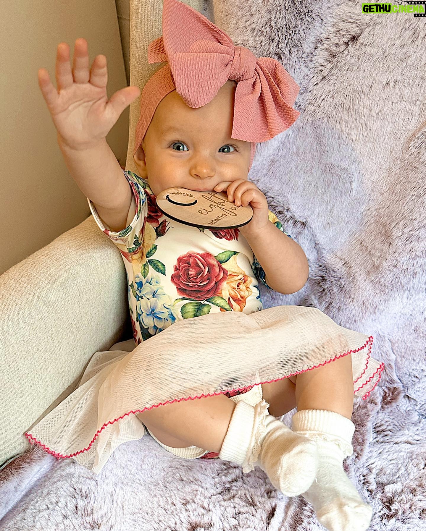 Alicia Banit Instagram - Our Isla Joy is 8 months old! She has a new cheeky smile where she squints her eyes and smiles with her whole face, she has 8 TEETH! with 5 popping through at the same time and surprise surprise she handled it like an absolute champ! She smiles at other people at the shops before they smile at her, she loooves looking at pictures of herself and she’s currently obsessed with waving 🥹 When she cries now she has tears which breaks our hearts but at the same time my god it’s CUTE! and she absolutely adores animals and other children. We still get told every single time we go out that we just have the happiest and chillest lil babe and honestly, I concur. Her personality is growing and evolving every day and we’ve loved nothing more than watching every second of it. My gosh we are the luckiest parents, I do not wish this time away at alllll but I also can’t wait to see who she becomes 🥹🤍