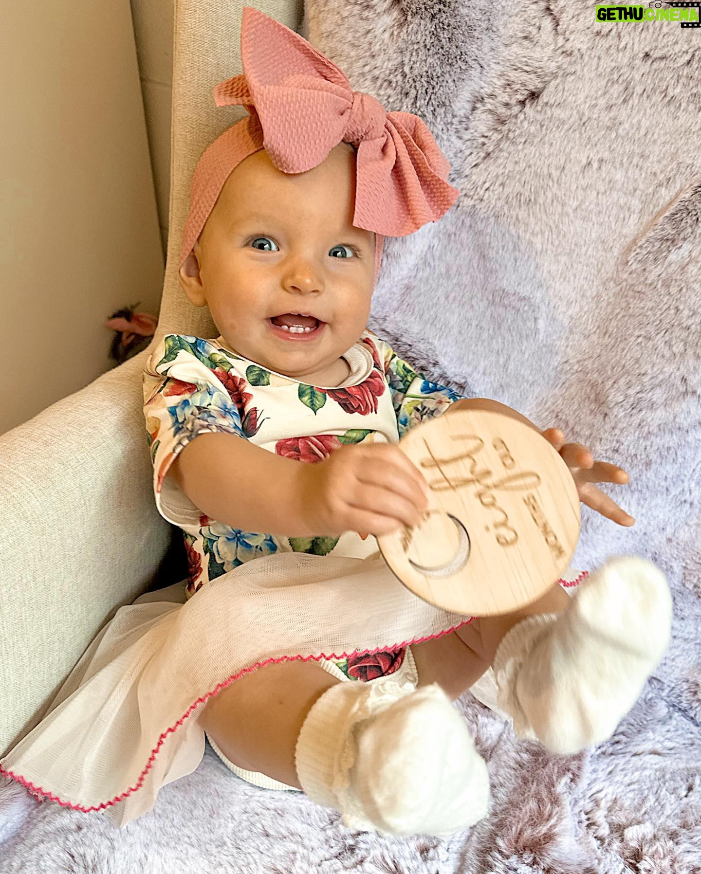 Alicia Banit Instagram - Our Isla Joy is 8 months old! She has a new cheeky smile where she squints her eyes and smiles with her whole face, she has 8 TEETH! with 5 popping through at the same time and surprise surprise she handled it like an absolute champ! She smiles at other people at the shops before they smile at her, she loooves looking at pictures of herself and she’s currently obsessed with waving 🥹 When she cries now she has tears which breaks our hearts but at the same time my god it’s CUTE! and she absolutely adores animals and other children. We still get told every single time we go out that we just have the happiest and chillest lil babe and honestly, I concur. Her personality is growing and evolving every day and we’ve loved nothing more than watching every second of it. My gosh we are the luckiest parents, I do not wish this time away at alllll but I also can’t wait to see who she becomes 🥹🤍