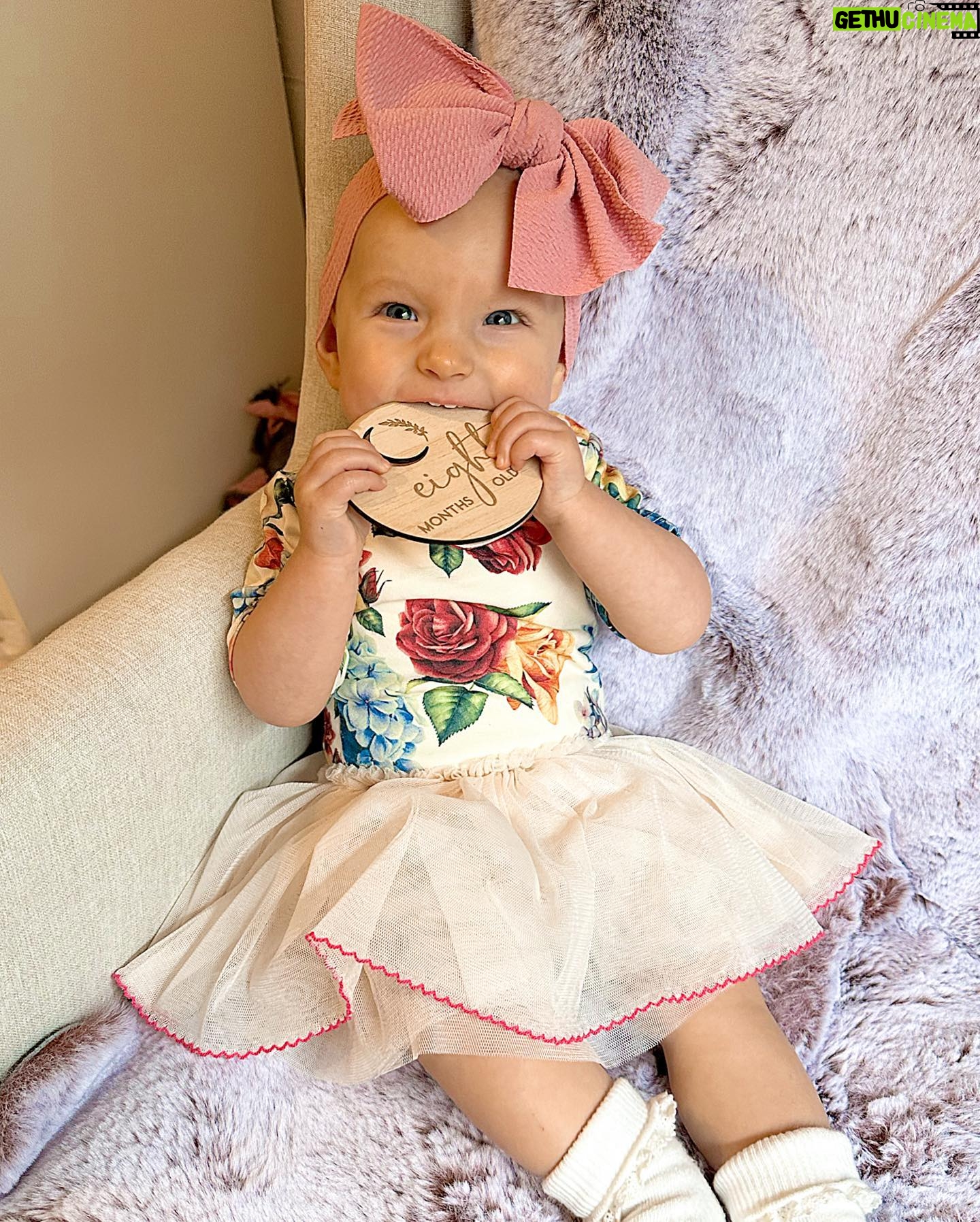 Alicia Banit Instagram - Our Isla Joy is 8 months old! She has a new cheeky smile where she squints her eyes and smiles with her whole face, she has 8 TEETH! with 5 popping through at the same time and surprise surprise she handled it like an absolute champ! She smiles at other people at the shops before they smile at her, she loooves looking at pictures of herself and she’s currently obsessed with waving 🥹 When she cries now she has tears which breaks our hearts but at the same time my god it’s CUTE! and she absolutely adores animals and other children. We still get told every single time we go out that we just have the happiest and chillest lil babe and honestly, I concur. Her personality is growing and evolving every day and we’ve loved nothing more than watching every second of it. My gosh we are the luckiest parents, I do not wish this time away at alllll but I also can’t wait to see who she becomes 🥹🤍