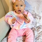 Alicia Banit Instagram – 7 months of our Isla Joy!

This little possum has a top tooth, has tried more foods than I can count and babbles MAMA among other words! I’m not sure she knows what she’s saying but I’m claiming it, her first word is definitely mama! She watches our mouths so intently when we try to teach her new words and she’s back in her dinosaur era roaring at everything. She whispers to herself and breathes like darth Vader when she’s bored and I honestly have never met a more smiley, laughable bub. Even through her first cold, our girl didn’t have a single day where she didn’t laugh and smile her way through it. We couldn’t be more in love with her, she is pure perfection 🥹