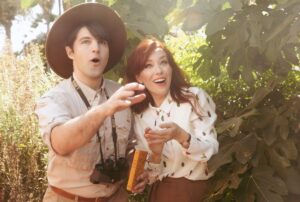 Alie Ward Instagram - True story: for our engagement photos 2 years ago, @jarrett_sleeper was like, what if we do some of them in tiny shorts or giant ballgowns? Absolutely solid strategy. But while @vonswank was taking them, a big green & gold fig eater beetle buzzed by in the @nhmla garden and landed on my finger. This first shot is maybe my favorite because it’s goofy and campy, but so earnest with honesty, wonder & curiosity — things I adore about @jarrett_sleeper. He has the fastest brain and the most generous heart. Today is our anniversary, but every day is learning something new & being rascals. Cut bangs, text your crush, enjoy who you have while you have them. 💖