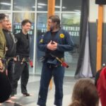 Alie Ward Instagram - Not JUST a lady blinking, a weird little critter & a handsome. Today was a big one in the Sleeper-Ward house, as @jarrett_sleeper — after two decades of practicing Brazilian jiu jitsu — got his black belt. Jiu jitsu to Mr. Sleeper is like a dog park for an Australian shepherd that lives in a condo. It calms him, and he’s really really fucking good at it. This guy went through quarantine without being able to roll, tore his ACL 3 years ago, spent so much time away from the mat to keep my dad safe from covid and care for him, and get strong again after not be able to practice. So today is a big one and I’m just so proud of him I can’t even handle it. Congrats to my dear @jarrett_sleeper and thank you for the daily inspiration to kick ass through gentle arts. I got him that Crocs charm months ago and hid it like an engagement ring for today.