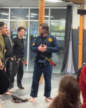Alie Ward Instagram - Not JUST a lady blinking, a weird little critter & a handsome. Today was a big one in the Sleeper-Ward house, as @jarrett_sleeper — after two decades of practicing Brazilian jiu jitsu — got his black belt. Jiu jitsu to Mr. Sleeper is like a dog park for an Australian shepherd that lives in a condo. It calms him, and he’s really really fucking good at it. This guy went through quarantine without being able to roll, tore his ACL 3 years ago, spent so much time away from the mat to keep my dad safe from covid and care for him, and get strong again after not be able to practice. So today is a big one and I’m just so proud of him I can’t even handle it. Congrats to my dear @jarrett_sleeper and thank you for the daily inspiration to kick ass through gentle arts. I got him that Crocs charm months ago and hid it like an engagement ring for today.