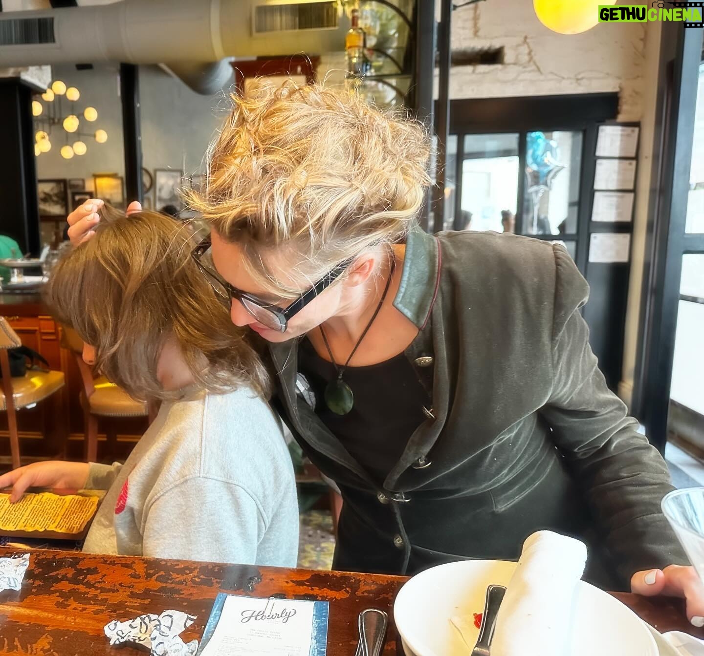 Amanda Palmer Instagram - Happy Sunday All. Me and my boy in Harvard Square at @thehourly02138 with Brendon and Geeta. Old friends. New eras. Old bricks. New patterns. Old habits. New hearts. Old glasses. New eyes. It’s spring and the pink blossoms are exploding and falling on the bricks, melting into time. Some things are so short. These blossoms. We have had a season (or two, or three, or fourteen?) of loss, but the remnants of loss are so precious, so fragile, so delicious. Lilies and coffins. Sandwiches and urns. Much of the day was spent explaining real estate, Harvard, forces of good and evil, education, money, protests, and war. Ash is wide open. His heart is filling with power. I love this. I love having an eight year old. It really did go so fast. I have been more inspired to write than ever before, and want to take to my desk this week to write about Star Wars, the myths children need in order to survive the relentless darkness of intergenerational trauma, and….lots of stuff. So many beautiful threads to connect in my little heart and head. I’ll publish, if I write, on the substack and cross-post to the patrons as usual. I am feeling so…loved. So secure, for the first time in a long time. And feeling so much love for all of you. This fragile season. May we all flourish. Wherever this finds you, I hope you’re feeling the cracks of light hitting your face, as I am. Happy spring. 🌱🎉 Photo by Geeta.