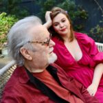 Amber Tamblyn Instagram - "I grew up in Southern California in an apartment building complex where I’d often spend evenings around a communal bonfire listening to my father, the artist, and acrobatic dancer, Russ Tamblyn, tell stories about the heydays of Hollywood. My dad starred in everything from the original West Side Story, to David Lynch’s Twin Peaks, rubbed elbows with the likes of Fred Astaire and Henry Miller, and is a beloved culture icon of sorts. You could hear a pin drop - or just the sounds of the crackling fire and my father’s voice - as neighbors and friends alike leaned in to listen closely to his stories of the adventures from his youth. There was the time he received his best friend, the actor Dennis Hopper, in bad shape over the border of Mexico in an ambulance. Or the time he picked up a strange hitchhiker who turned out to be Charles Manson, and his harem of women in Topanga. Or the time he helped Elvis Presley with some dance moves for “Jailhouse Rock.” Or the time his other best friend, the songwriter Neil Young, wrote one of his most famous songs in the backseat of dad’s car on a road trip. Or the time dad turned down that lead role in “Gilligan’s Island.” Or the second time he met the Queen of England. Those stories are just a fraction of his life, and what he writes about in his new memoir, Dancing on the Edge: A Journey of Living, Loving, and Tumbling Through Hollywood. At 89 years old, I like to think it’s a pretty amazing feat, to have come this far, literally and professionally; to have lived for so long, and so hard, and so good, as my dad has, and get to publish a book about it—his first book!— in his golden years. May we all be so fortunate. (Especially the living part.) For The Bare Magazine, I sat down with my dad in my backyard in Brooklyn, New York during his recent press tour for the book to talk about some of his favorite memories from growing up in Hollywood, thinking about life’s biggest regrets at the end of the road, and of course, the essential products he can’t live without (spoiler alert: one of them is a cologne he has worn since I was born, and still wears to this day.)" -- @amberrosetamblyn @officialrusstamblyn ♥️ #linkinbio