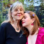 Amber Tamblyn Instagram - *Sings in the key of Maya Rudolph* SHE’S. MY. MOTHER. Happy birthdays to me and my mom @bonnietamblyn (mine’s today, hers is tomorrow May 15th.) In honor of her birthday, please check out or donate to @topainstitute (The Ojai Foundation) an organization gathering leaders, facilitators, artists, teachers and students in honoring global traditions of perennial wisdom that create peace, healing, art, learning, and most importantly: listening. This organization has been my mom‘s life work, and the world is better off for it. Happy birth, birthed, and birthing days to us! I love you so much mom! 🌺 📸 of me and my mom: @tina_turnbow Dress by @ruesaintpaul Matching purple flowers in our hair: my daughter Marlow