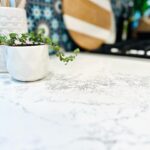 Amy Davidson Instagram - Working with @caesarstoneus for our kitchen countertops was a total dream! Our designer, Cynthia of @sodapopdesigninc loves their stone and when she introduced me, I was instantly sold! We knew we wanted chic, white countertops and when we saw the final design (Cynthia had chosen Empira white) it’s like she had read my mind. 🙌🏻 The waterfall edge!!!! Omigoodness, it’s even more stunning in person! 🤩 The veins in the stone are so unique. Some of them trail off on their own, and other veins clump into their own beautiful designs. CaesarStone slabs truly look like art. ✨ And bonus— they are easy to clean, maintain and are very durable. Thank you Cynthia and CaesarStone for making my dream kitchen come to true❣️🫶🏻❣️