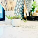 Amy Davidson Instagram - Working with @caesarstoneus for our kitchen countertops was a total dream! Our designer, Cynthia of @sodapopdesigninc loves their stone and when she introduced me, I was instantly sold! We knew we wanted chic, white countertops and when we saw the final design (Cynthia had chosen Empira white) it’s like she had read my mind. 🙌🏻 The waterfall edge!!!! Omigoodness, it’s even more stunning in person! 🤩 The veins in the stone are so unique. Some of them trail off on their own, and other veins clump into their own beautiful designs. CaesarStone slabs truly look like art. ✨ And bonus— they are easy to clean, maintain and are very durable. Thank you Cynthia and CaesarStone for making my dream kitchen come to true❣️🫶🏻❣️