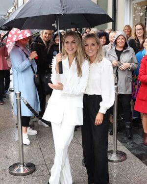 Amy Huberman Instagram - A massive thank you to the brilliant @ayumakeupireland team  for gorgeous launch today. So chuffed to be the face of your Christmas campaign and thank you guys for having me, what a fab Irish brand you have built @suzie.ayu you are a powerhouse 💚☘️ And congratulations on the opening of your brand new sparkling store in Kildare Village ✨
Full sidewise pelting rain with  floor length flares soggy to the knee; the ONLY way to glam up of a morn.
The suit is @nadinemerabi I wore to the book awards last year which I had 💯 percent forgotten to dry clean. I mean what could possibly go wrong with a full white suit?! Jesus. Looked like I might have been dipped, rolled and soaked in a full bath of Guinness. And I don’t even drink Guinness. My local dry cleaners are complete dreamboat magicians.  Thank you for a gorgeous morning @ayumakeupireland you are a indeed gorgeous team #paidpartnership